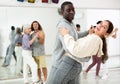 Dancing positive couples learning salsa Royalty Free Stock Photo