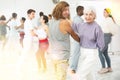 Dancing positive couples learning salsa Royalty Free Stock Photo