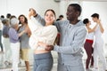 Dancing positive couples learning salsa Royalty Free Stock Photo