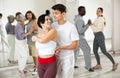 Dancing positive couples learning salsa Royalty Free Stock Photo