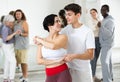 Dancing positive couples learning salsa Royalty Free Stock Photo