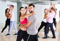 Dancing couples learning salsa at dance class Royalty Free Stock Photo