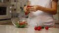 Dancing pregnant woman preparing a salad. Healthy pregnancy concept Royalty Free Stock Photo