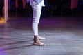 Dancing shoes feet and legs of male ballroom and latin salsa dancer dance teacher on the stage. Social dance, bachata