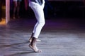 Dancing shoes feet and legs of male ballroom and latin salsa dancer dance teacher on the stage. Social dance, bachata