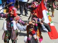 Dancing devotees with mask in the streets of the town the procession of the Virgin of Carmen Paucartambo Cuzco Peru