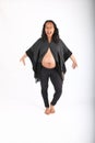 Dancing and singing pregnant woman in grey poncho Royalty Free Stock Photo