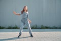 Dancing teen girl cool moving outdoors on urban background. Energetic cool young dancer showing hip hop dance on street Royalty Free Stock Photo