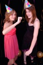 Dancing teens in party hats Royalty Free Stock Photo