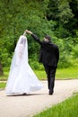 Dancing wedding couple at a park Royalty Free Stock Photo