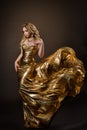 Dancing Woman in Gold Dress Flying on Wind, Beautiful Lady in Fluttering Sparkling Golden Gown Royalty Free Stock Photo