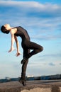 Dancing woman over blue sky. Yoga Royalty Free Stock Photo