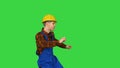 Dancing young engineer with helmet after work on a Green Screen, Chroma Key.