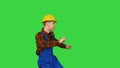 Dancing young engineer with helmet after work on a Green Screen, Chroma Key.