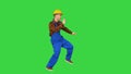 Dancing young engineer with helmet after work on a Green Screen, Chroma Key.