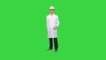 Dancing young engineer with helmet after work on a Green Screen, Chroma Key.