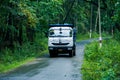 "Dandeli,Karnataka,India- 6th october 2021:The TATA signa 4825 tipper travelling through lush green forest, tipper used for
