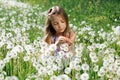 Dandelion field white girl beautiful happy little baby green meadow yellow flowers dandelions nature park garden Royalty Free Stock Photo