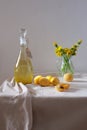 Dandelion homemade wine in a glass bottle on table. Light background Royalty Free Stock Photo