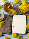 Dandelion honey in jar and notebook