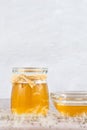 Dandelion jam, honey, jelly in a glass jar on a wooden table, white background with fresh flowers, dandelion airy seed Royalty Free Stock Photo