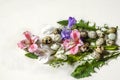 Dandelion leaves,quail eggs with flowers of pink and white Alstroemeria and branches of purple iris against white plywood