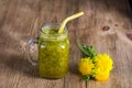 Dandelion yellow flower tea drink in glass mug on wooden table. Concept of healthy eating, herbal flower tincture Royalty Free Stock Photo