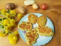 Dandelions flowers with potatoes and onion burgers