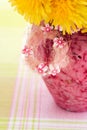 Dandelions in a pink vase