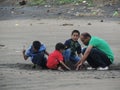 Tourists trying to build castle at Dandi Beach at dawn - Gujarat tourism - India beach holiday - Historical Royalty Free Stock Photo