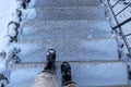 Danger of accident on snow-covered slippery steps of stairs in winter