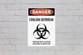 Danger cholera outbreak sign on a wall
