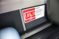 Danger dafety information sign inside interior of public transport bus warning passengers