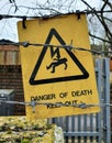 A danger of death sign surrounded by barbed wire