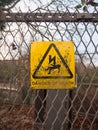 danger of death yellow rusty dirty unclean sign on metal fence l Royalty Free Stock Photo
