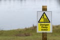 Danger Deep Water sign on a wooden post