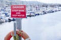 Danger deep water and steep bank at sea harbour marina