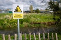 Danger Deep Water warning sign by rural waterway river hazard. Risk of falling in and drowning. Royalty Free Stock Photo