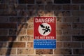 Danger, do not enter sign and symbol on brick wall Royalty Free Stock Photo