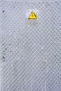 Danger of electrocution yellow sign on gray. High voltage warning sign Royalty Free Stock Photo