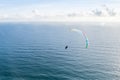 Danger extreme flying tandem paraglider over the sea