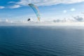 Danger extreme flying tandem paraglider over the sea