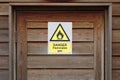 Danger flammable gas warning caution sign on wooden door