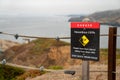 Danger hazardous cliffs stay back from edge sign on rope safety boundary warning visitors on hiking path Royalty Free Stock Photo