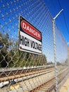 Danger High Voltage Sign along Electrified Rail. Royalty Free Stock Photo