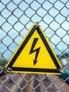 `Danger! High Voltage!` sign. Yellow sign with lightning in triangle Royalty Free Stock Photo