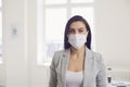 Danger of infection of the virus coronavirus infection. Businesswoman in medical mask at office