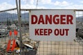 `Danger Keep Out Authorised Personnel Only` sign board on fence gate at construction site