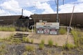 Warning danger signs with coal train wagons.