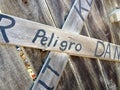 Danger keep out peligro sign painted on wood fence Royalty Free Stock Photo